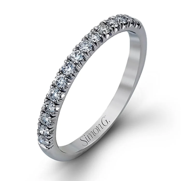 This elegant classic white gold halo engagement ring and band is set with .78 ctw of sparkling round cut white diamonds.