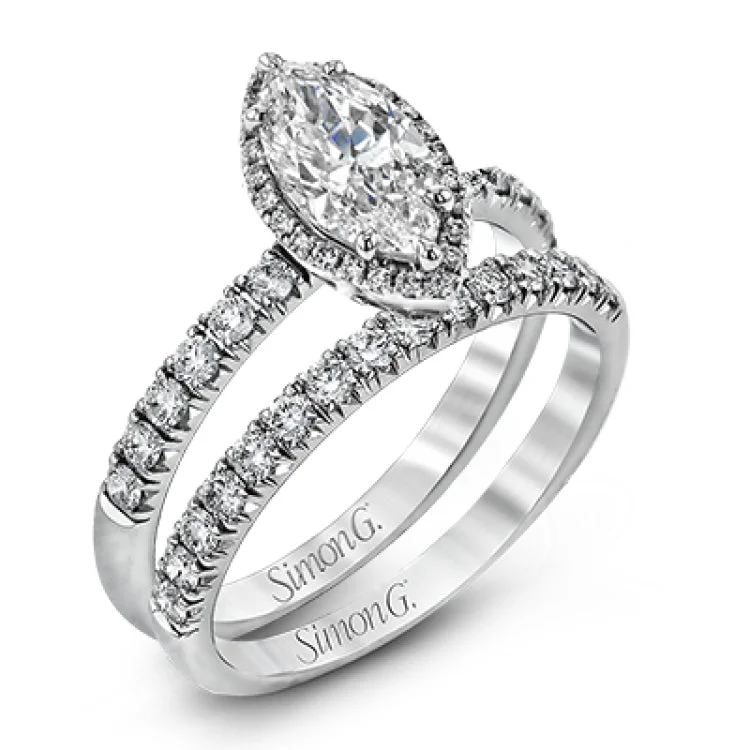 This elegant classic white gold halo engagement ring and band is set with .78 ctw of sparkling round cut white diamonds.