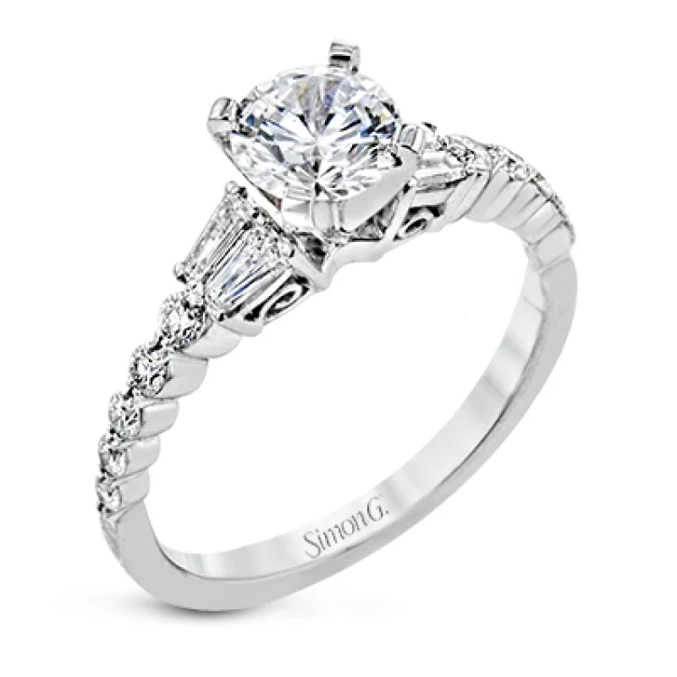 This wedding set stands apart with a unique design featuring two tapered baguette side stones on either side of the center stone, along with .43 ctw of round white accent diamonds.