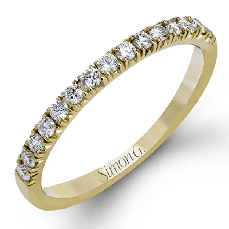 This elegant classic white gold halo engagement ring and band is set with .78 ctw of sparkling round cut white diamonds.