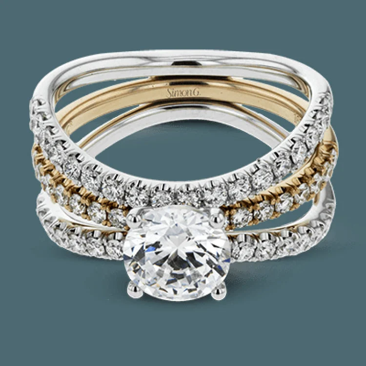 This distinctive bridal set design features a double-layer wedding band that fits around the engagement ring. The set contains .77 ctw of white diamonds.