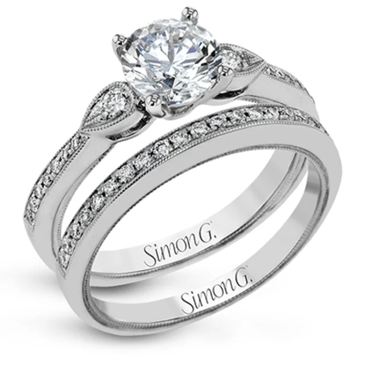 This unique diamond engagement ring 0.30 ctw., features a 3-stone design for a RD center, with 2 round sides set in a delicate migrain beading and diamonds along the shank