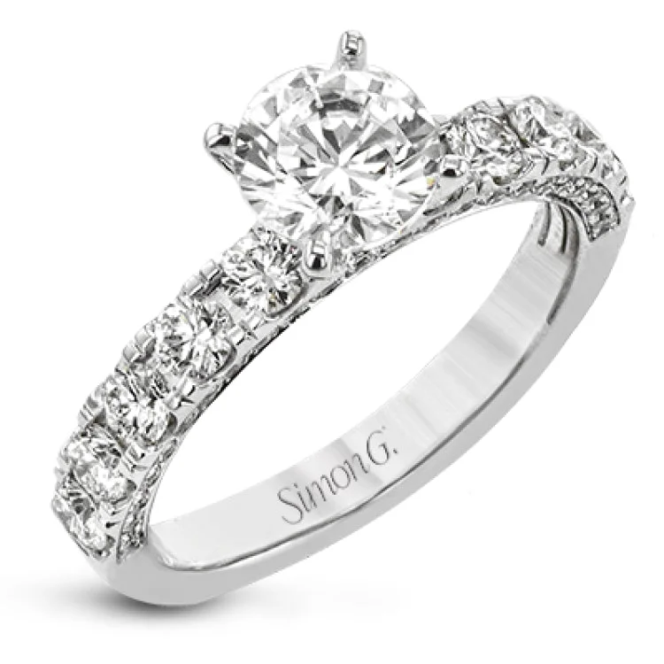 This engagement ring is stunning from every side, with .97 ctw of white round diamonds on the top and sides of the ring.