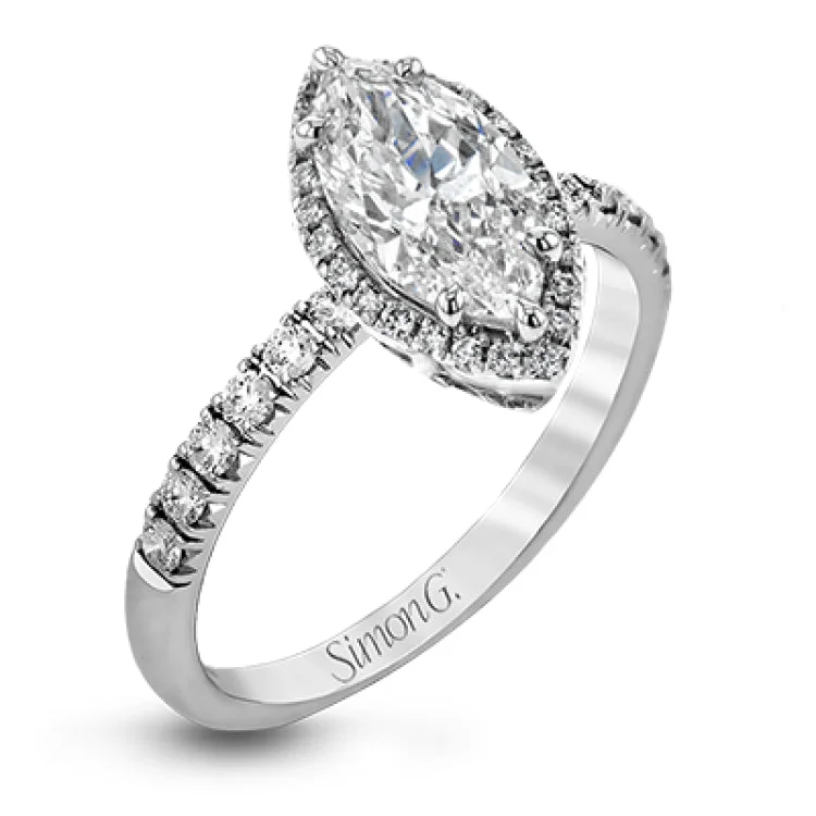 This elegant classic white gold halo engagement ring and band is set with .78 ctw of sparkling round cut white diamonds.