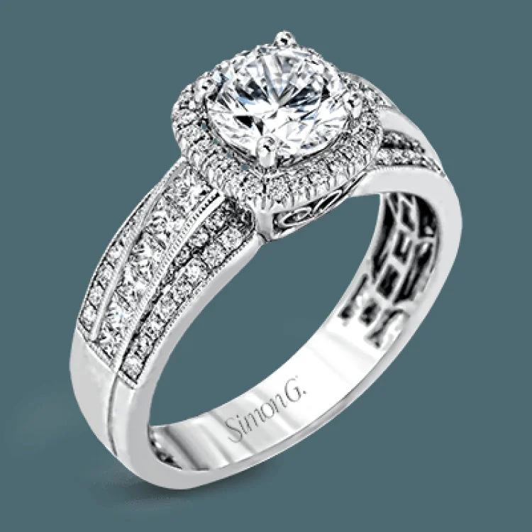 Featuring an impressive halo, this contemporary white gold engagement ring is accented by .22 ctw of round cut white diamonds and .42 ctw princess cut diamonds.