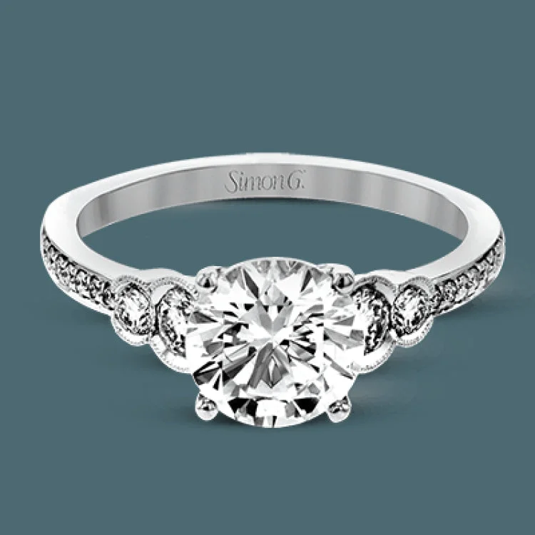 Timelessly beautiful, this white gold engagement ring's stunning design features .44 ctw of round white diamonds flanking the center stone with a lovely tapered effect.