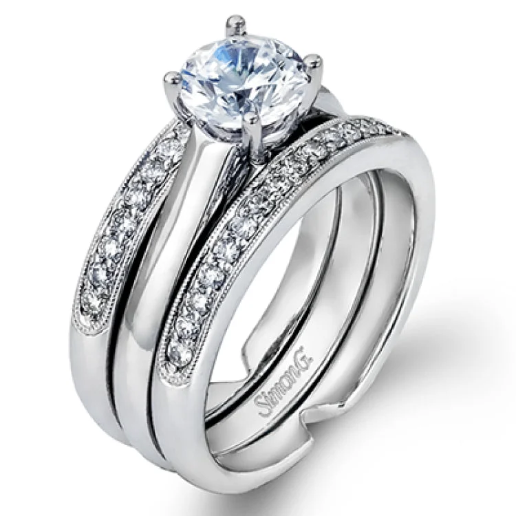 A classic diamond wedding set in white gold, features a high polish solitaire nestled in between a guard with brilliant white diamonds 0.35 ctw.