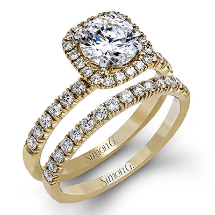 This elegant classic white gold halo engagement ring and band is set with .78 ctw of sparkling round cut white diamonds.