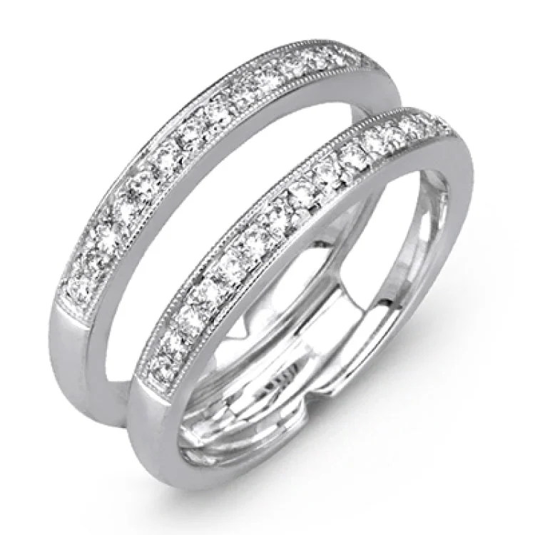 A classic diamond wedding set in white gold, features a high polish solitaire nestled in between a guard with brilliant white diamonds 0.35 ctw.