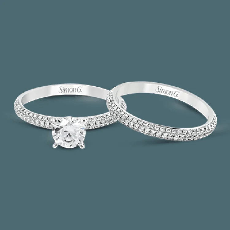 This lovely wedding set features a rounded design which is pave set with .53 ctw of white diamonds.