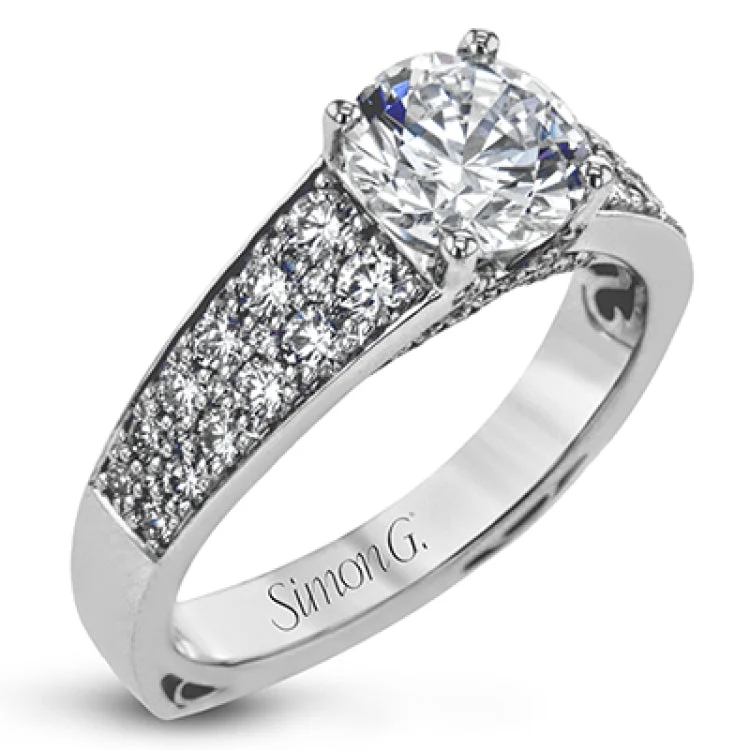 This elegant diamond engagement ring from our Simon Set collection shimmers with 0.70 ctw of brilliant white diamonds in a cathedral setting & on the profile.