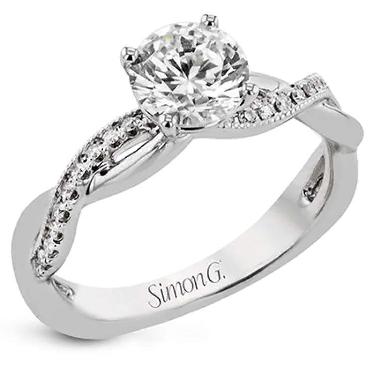 This delicate engagement ring features an infinity twist design with a high polish side, and a diamond accented side 0.15 ctw., set in 18K white gold.