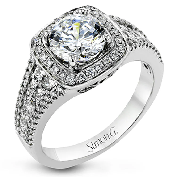 A classic Simon G. design, this stunning engagement ring has a low set center with a cushion shaped diamond halo 0.23 ctw and 4 rows of diamonds on the band 0.45 ct PC & 0.08 ct RD.