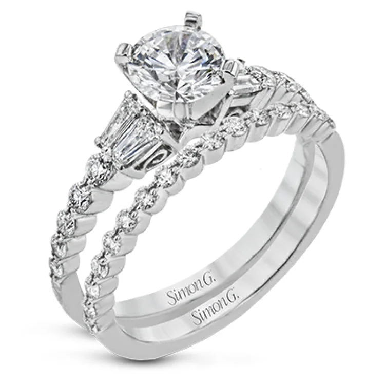 This wedding set stands apart with a unique design featuring two tapered baguette side stones on either side of the center stone, along with .43 ctw of round white accent diamonds.