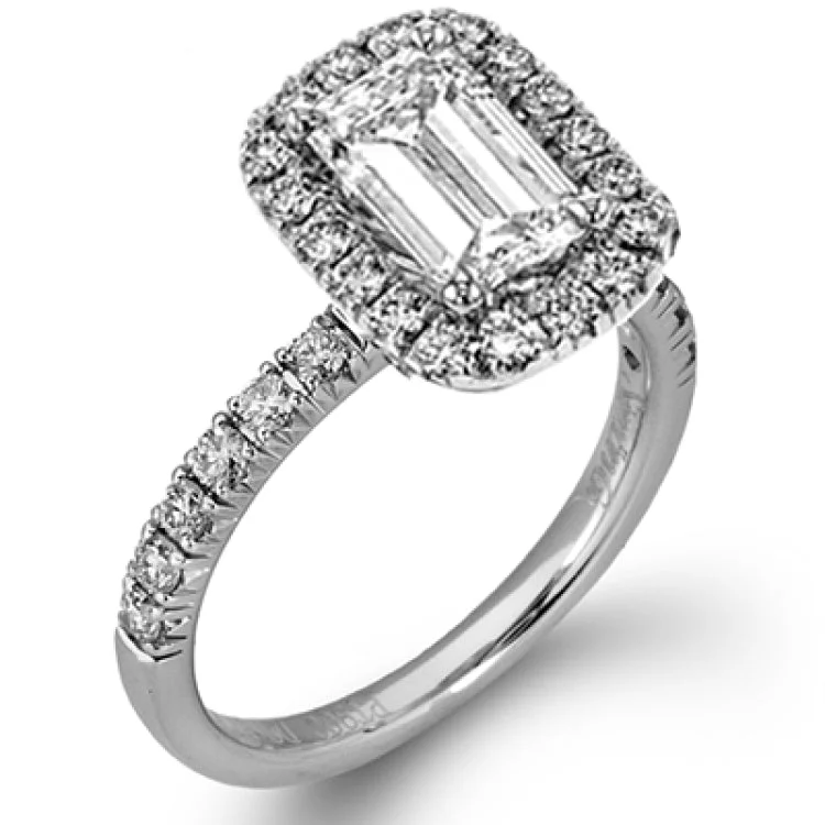 This elegant classic white gold halo engagement ring and band is set with .78 ctw of sparkling round cut white diamonds.