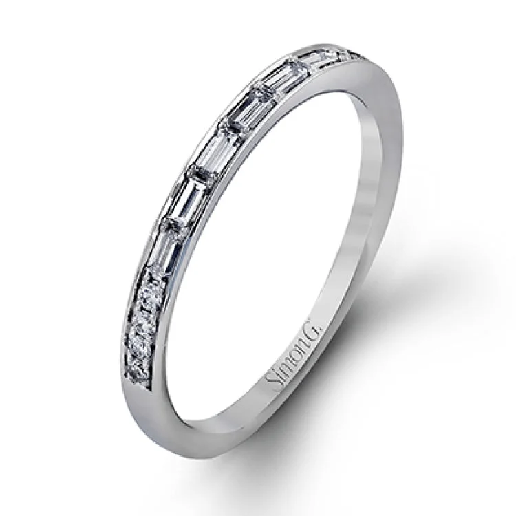 Contemporary in its design, this white gold engagement ring features .17 ctw of round cut white diamonds highlighted by .50 ctw of tapered baguette cut side diamonds.