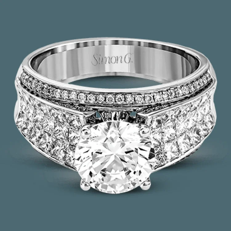 Presenting an eye-catching contemporary design, this white gold engagement ring features 1.31 ctw of princess cut white diamonds accented by .21 ctw of round cut white diamonds.