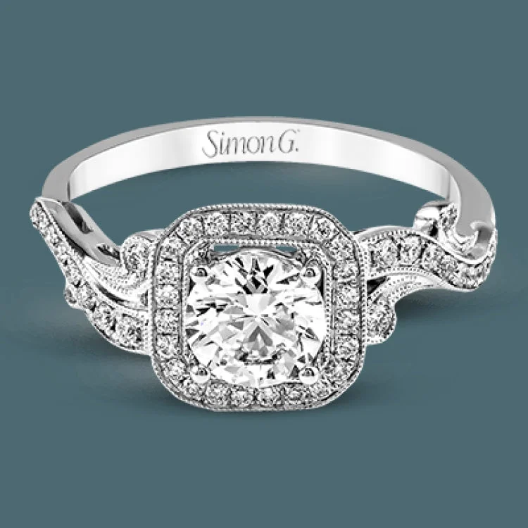 Featuring an elegant design, this white gold classic engagement ring is accented with .25 ctw round cut white diamonds.