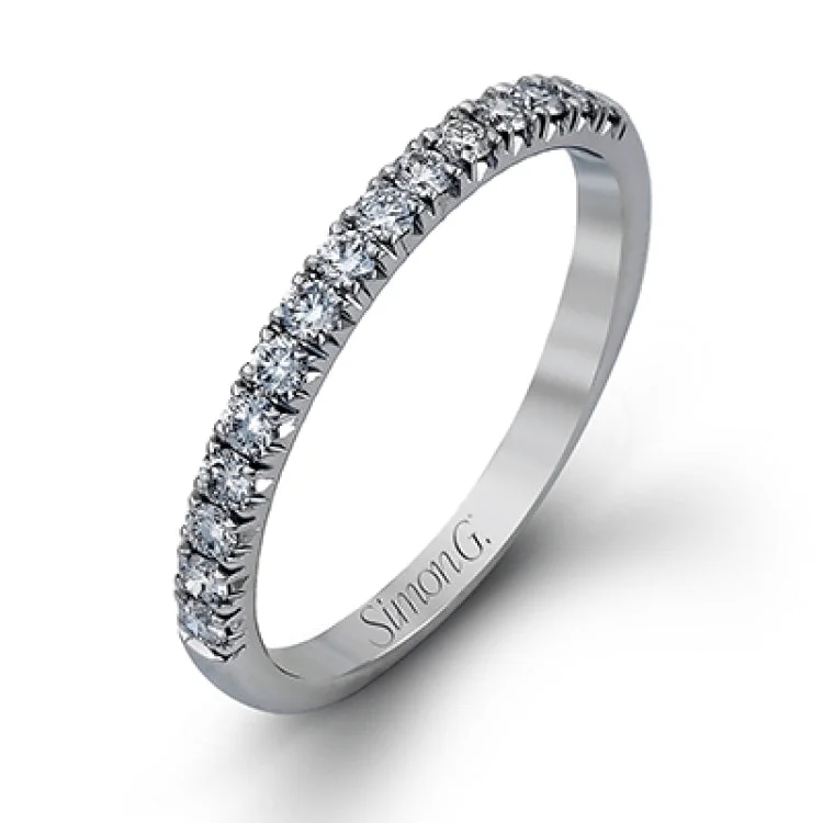 This elegant classic white gold halo engagement ring and band is set with .78 ctw of sparkling round cut white diamonds.