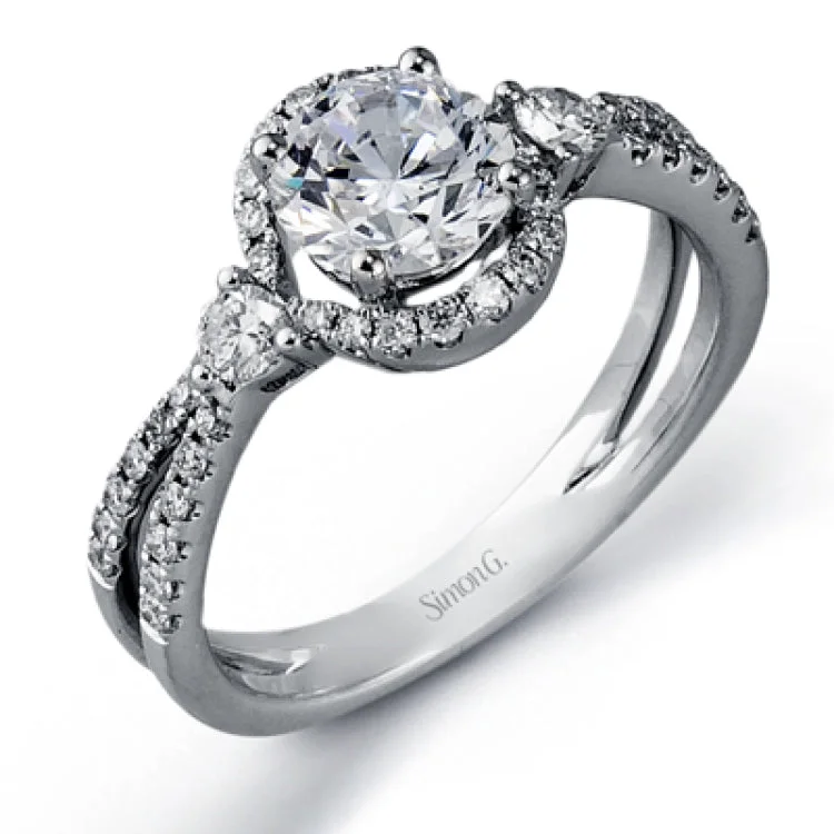 This unique diamond engagement ring features a 3-stone design for a RD center with halo, 2 round sides 0.14 ctw., and white diamonds on a split shank 0.24 ctw.