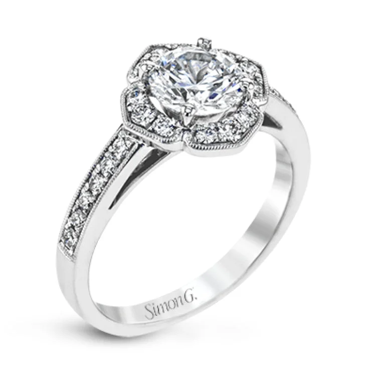 A floral inspired diamond engagement rng 0.35 ctw. has a vintage touch of milgrain beading, and is made to hold a 1.0 ct center