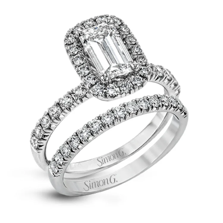 This elegant classic white gold halo engagement ring and band is set with .78 ctw of sparkling round cut white diamonds.