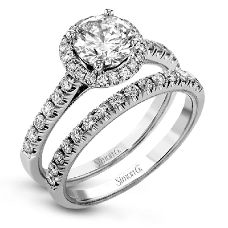 This enchanting bridal set features a cathedral mount engagement ring with diamond halo 0.39 ctw., and diamond band 0.27 ctw