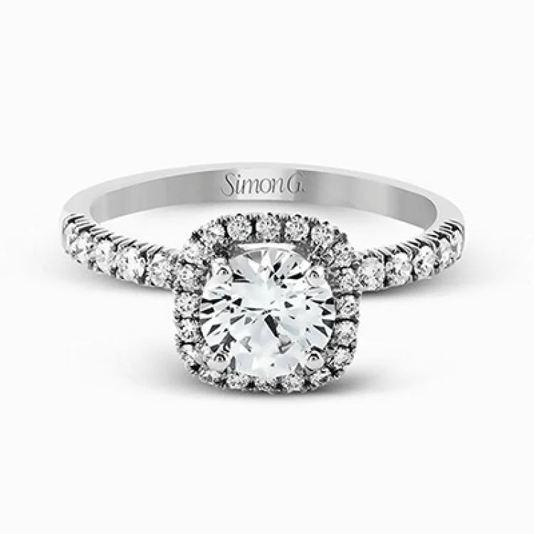 This elegant classic white gold halo engagement ring and band is set with .78 ctw of sparkling round cut white diamonds.