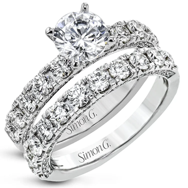 This engagement ring is stunning from every side, with .97 ctw of white round diamonds on the top and sides of the ring.