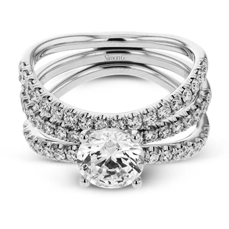 This distinctive bridal set design features a double-layer wedding band that fits around the engagement ring. The set contains .77 ctw of white diamonds.