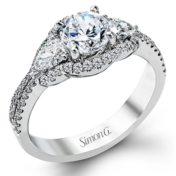 This unique diamond engagement ring features a 3-stone design & takes a RD center with 2 pear shaped sides 0.34 ctw, and is outlined by round white diamonds 0.37 ctw.