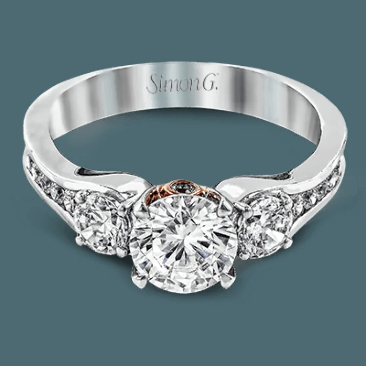 The classic design of this white gold engagement ring is highlighted by .20 ctw of round cut white diamonds and accentuated by .48 ctw of round cut white side diamonds.