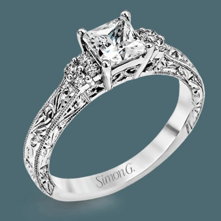 Featuring a dazzling vintage design, this romantic white gold engagement ring is highlighted by .15 ctw of striking white diamonds.