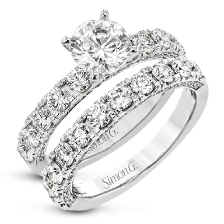 This engagement ring is stunning from every side, with .97 ctw of white round diamonds on the top and sides of the ring.