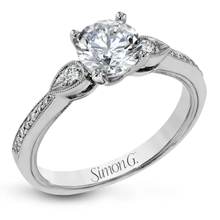 This unique diamond engagement ring 0.30 ctw., features a 3-stone design for a RD center, with 2 round sides set in a delicate migrain beading and diamonds along the shank