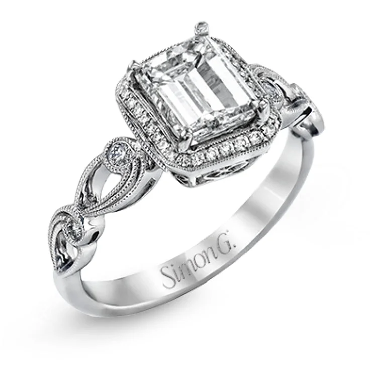 Reflecting a lovely romantic design, this white gold classic engagement ring features .16 ctw round cut white diamond accents.