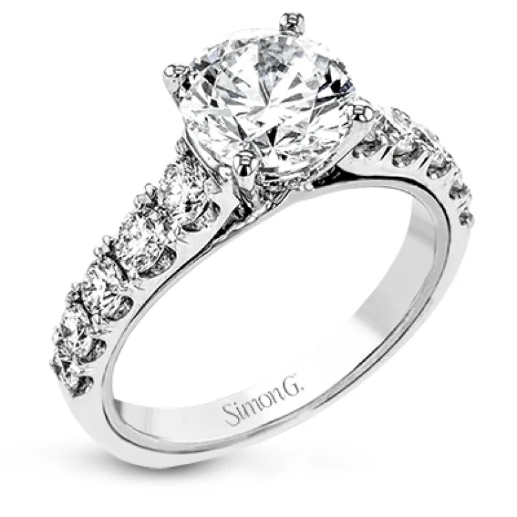 A beautiful row of .86 ctw of significant diamonds leads up to the center stone in this timeless engagement ring design.