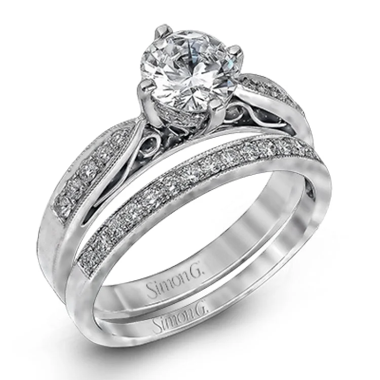 This distinctive wedding set features vintage style details and .34 ctw of white diamonds.