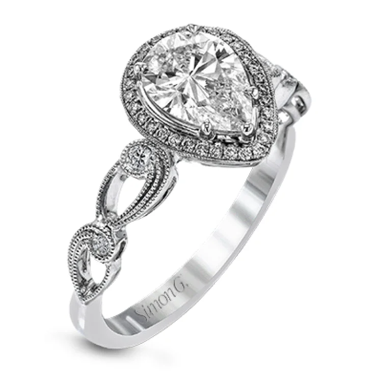 Reflecting a lovely romantic design, this white gold classic engagement ring features .16 ctw round cut white diamond accents.