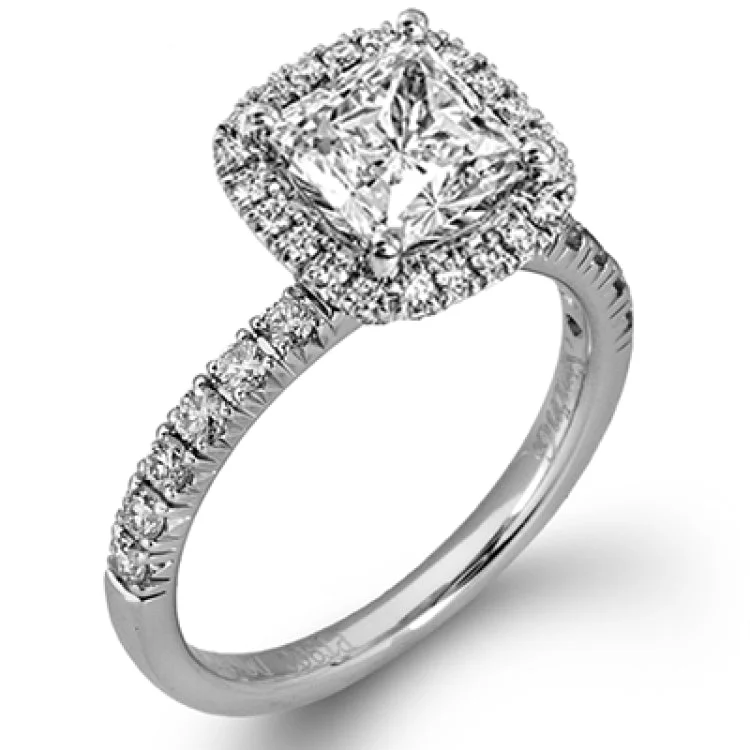 This elegant classic white gold halo engagement ring and band is set with .78 ctw of sparkling round cut white diamonds.